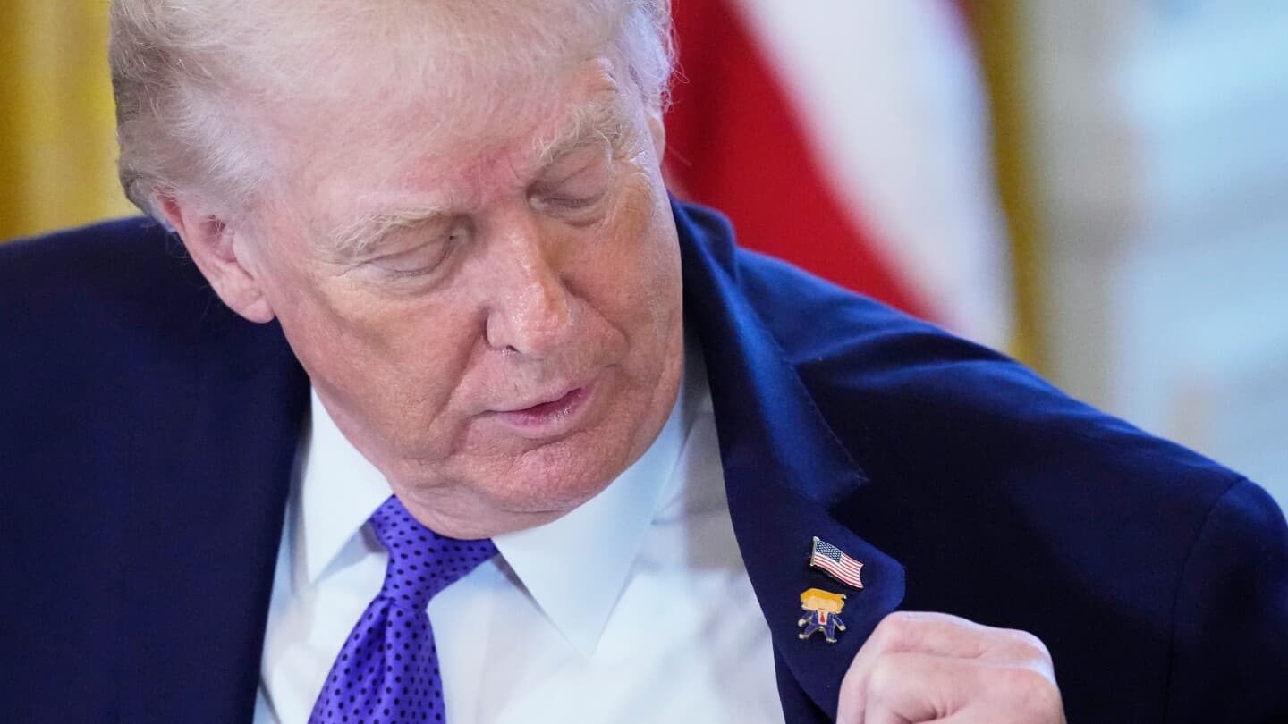 Trump wears a new 'Happy Trump' lapel pin, but insists he's never happy - Featured Image