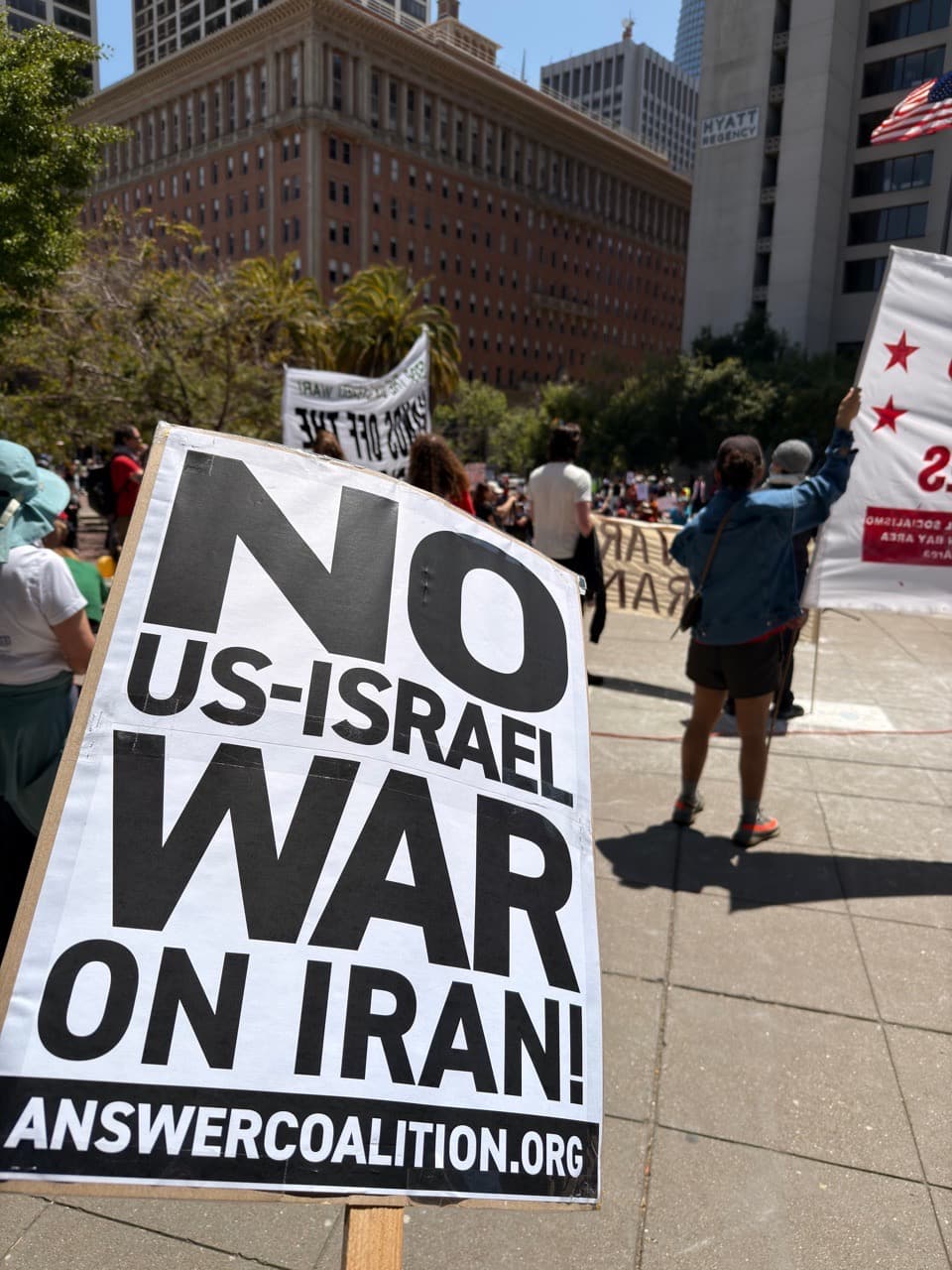 A protest sign, the text says "No US-Israel War on Iran"